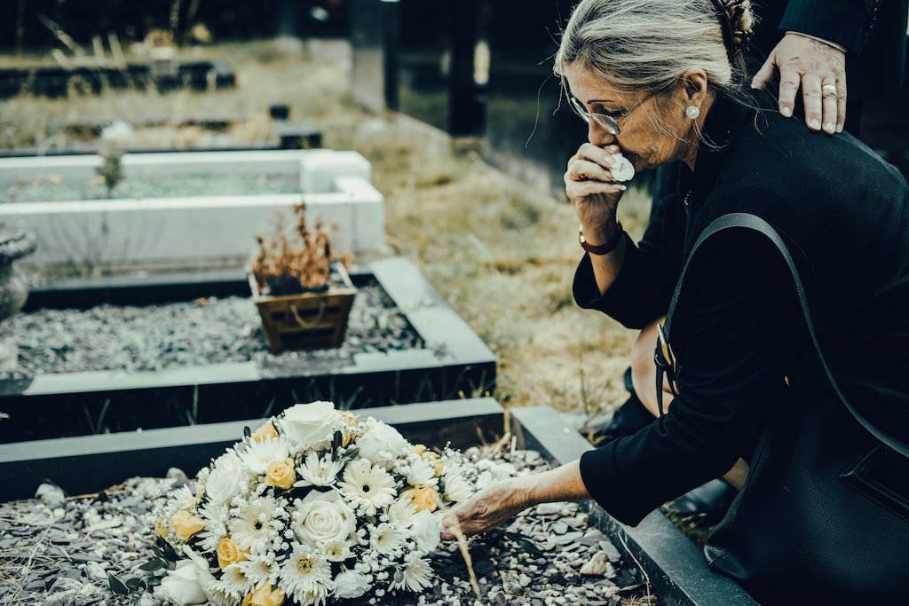 A quiet moment of remembrance at a graveside