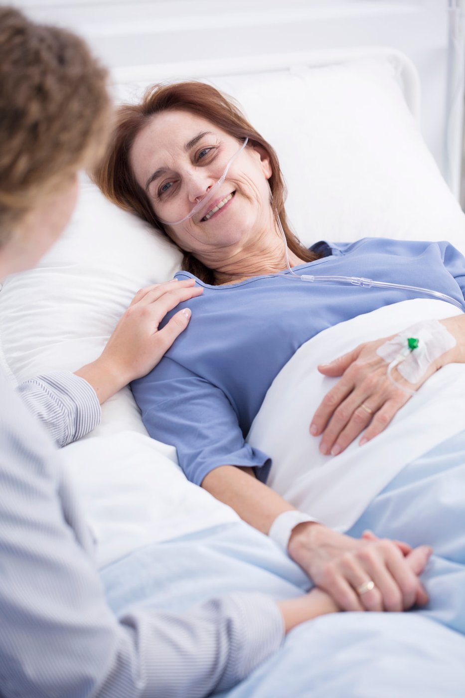 A reassuring hand resting on a person in a care setting