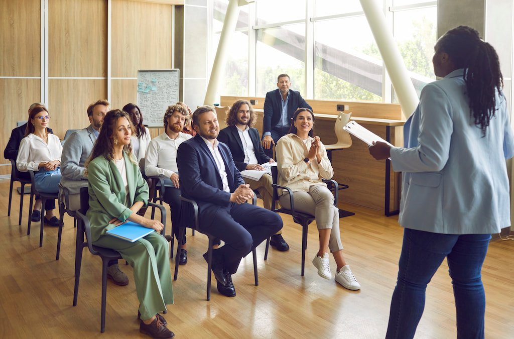 A facilitator speaking with a group at an educational workshop